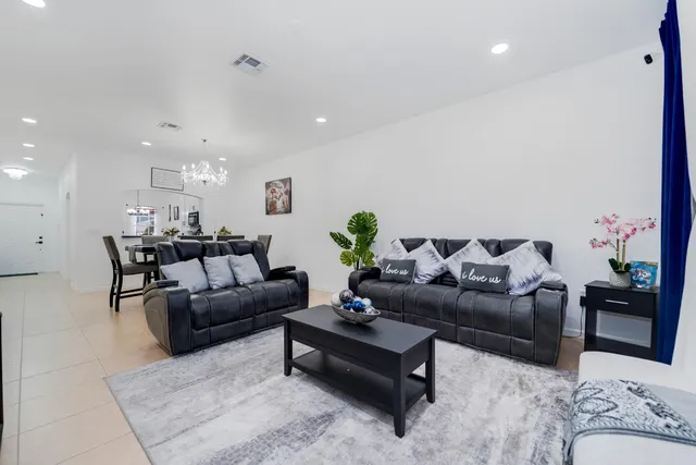 a living room with furniture and flowers