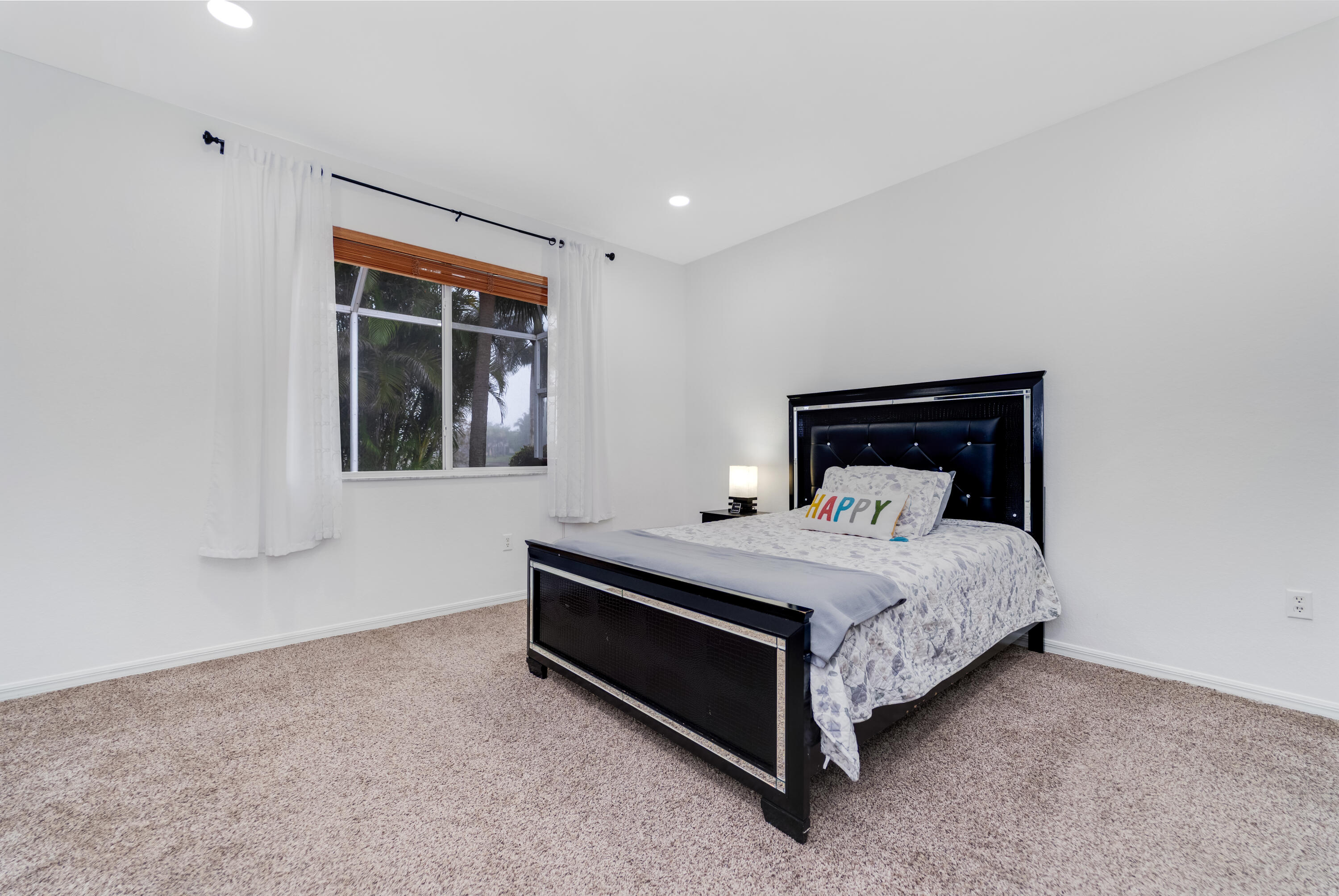 14190 Fall Creek Court Naples, FL 34114 - Photo 22 of 25 a bedroom with a bed and window