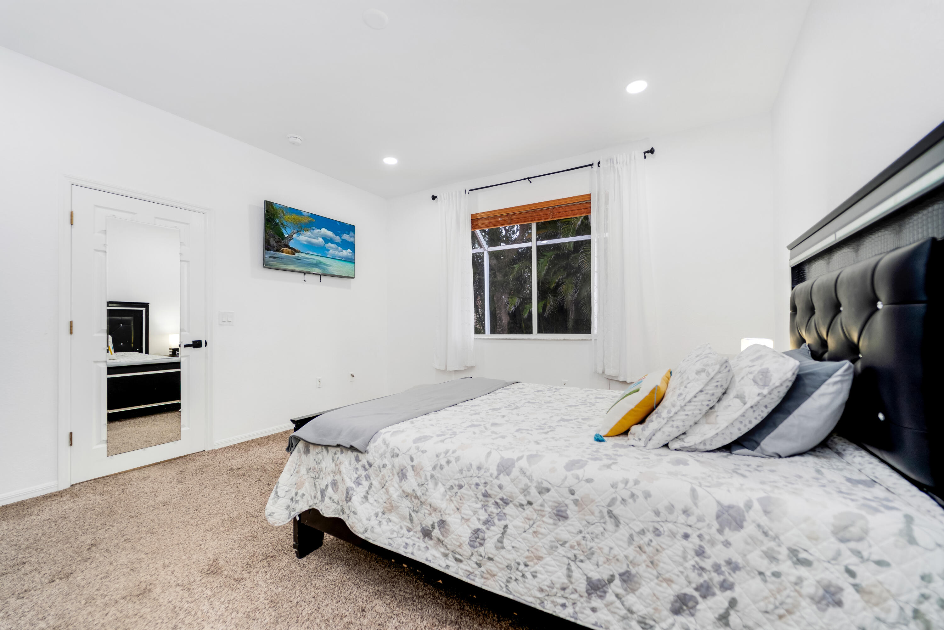14190 Fall Creek Court Naples, FL 34114 - Photo 23 of 25 a bedroom with a bed and a flat screen tv