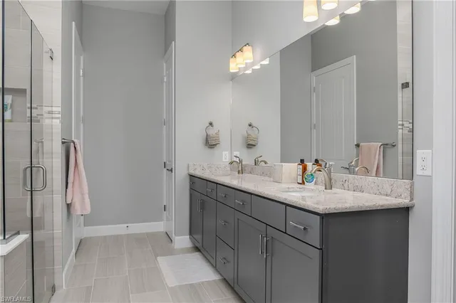 a bathroom with a sink vanity granite and a mirror