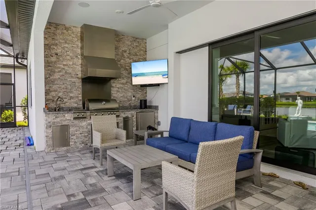 a living room with patio furniture and a fireplace
