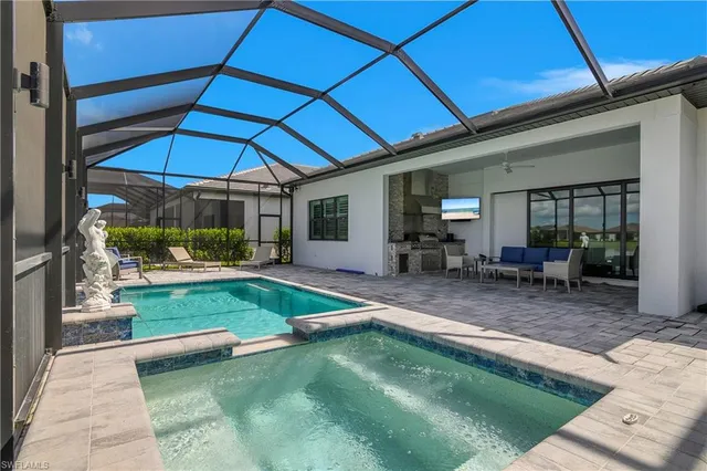 a view of a patio with table and chairs under an umbrella
