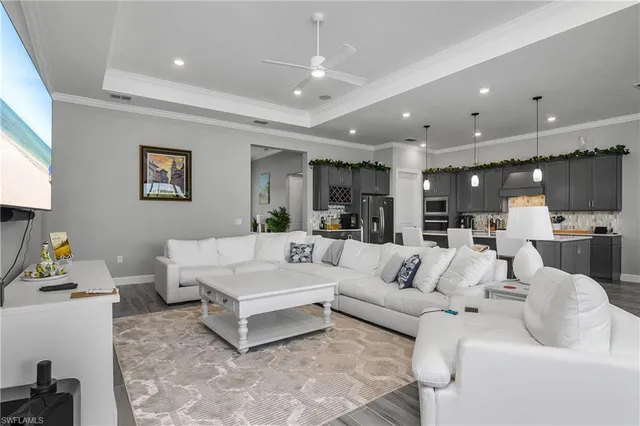 a living room with furniture and kitchen view