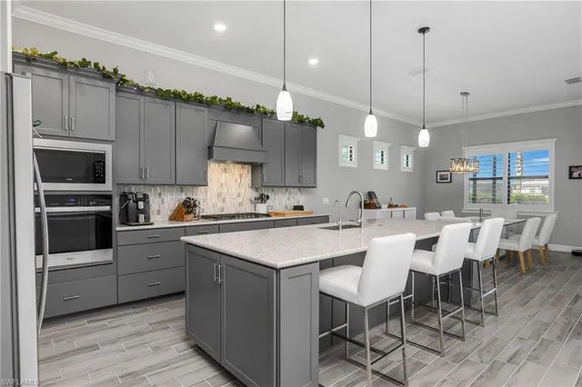 a large kitchen with a table and chairs