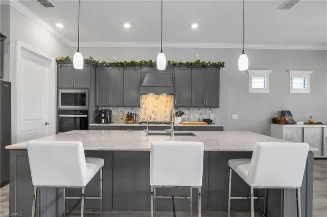 a kitchen with kitchen island granite countertop a table and chairs in it