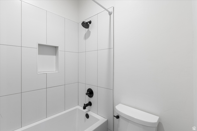1192 East Corral Way Washington, UT 84780 - Photo 52 of 81 White tiled shower and bathtub combination featuring matte black fixtures and an integrated shower niche