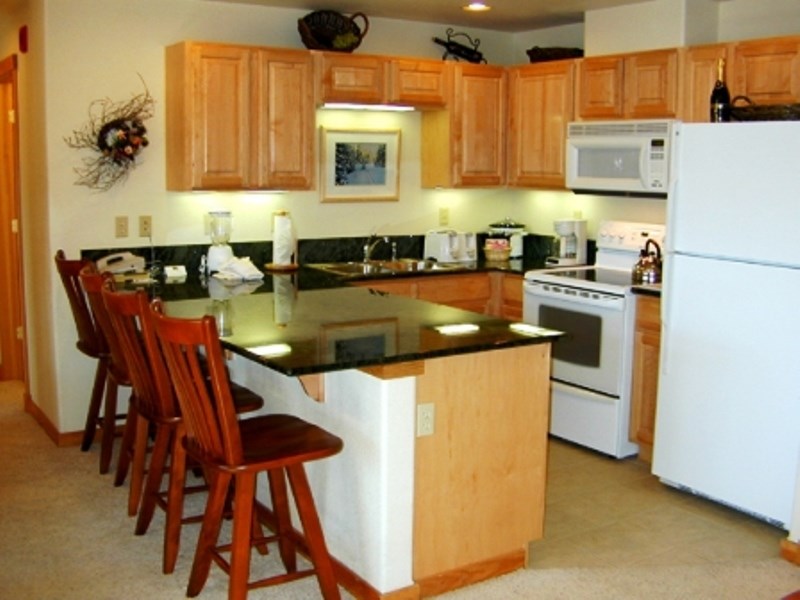 75 Snowflake Drive, Unit 227 Breckenridge, CO 80424 - Photo 2 of 15 a kitchen with stainless steel appliances granite countertop a sink and a refrigerator