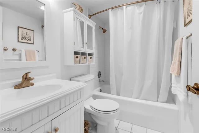 a bathroom with a sink a toilet and shower curtain