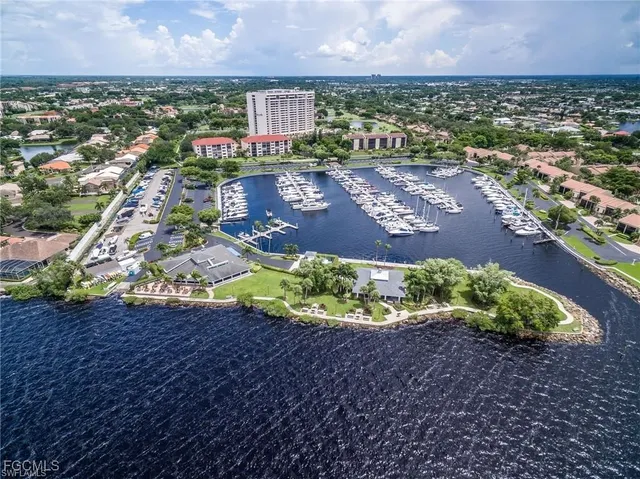 an aerial view of a house with a yard and lake view in back