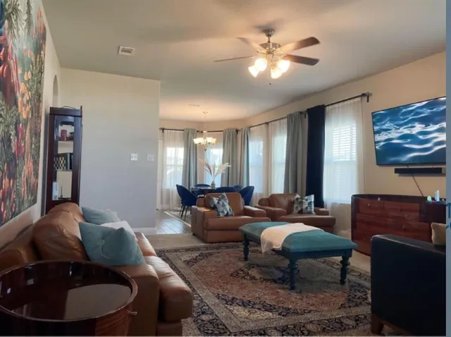 a living room with furniture a lamp and a chandelier
