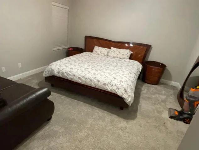 a bedroom with a bed and a chair