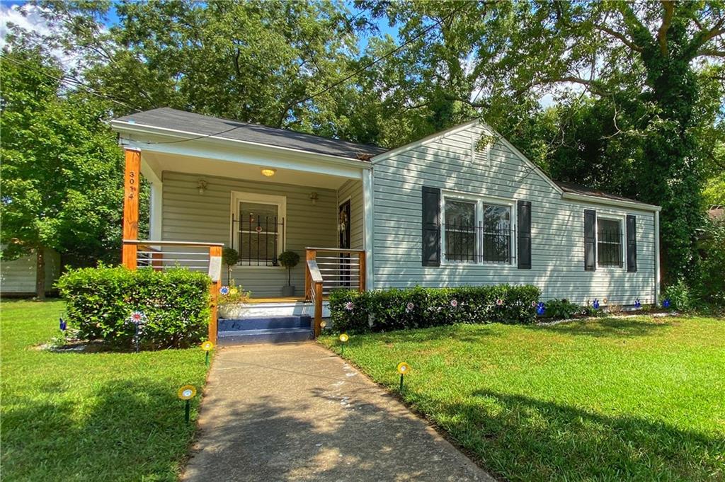 3014 East Point Street East Point, GA 30344 - Photo 1 of 1 a front view of a house with a yard and outdoor seating