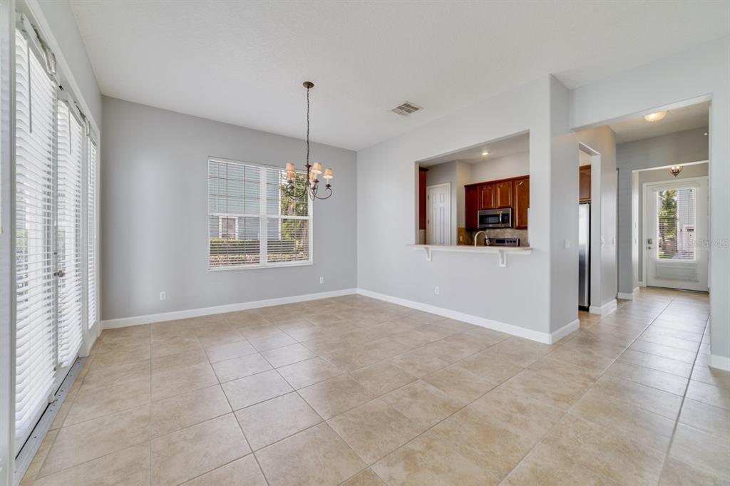 1426 Fairview Circle Reunion, FL 34747 - Photo 14 of 35 a view of an empty room with kitchen and window