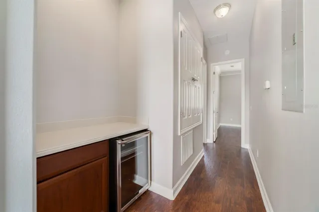 a kitchen with white cabinets and wooden floor