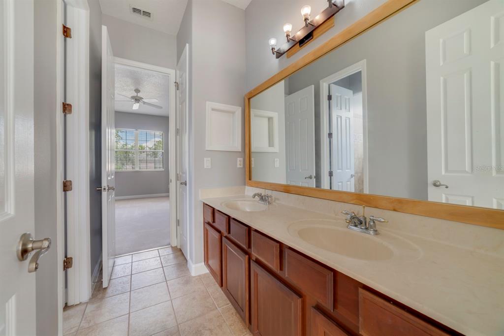 1426 Fairview Circle Reunion, FL 34747 - Photo 20 of 35 a bathroom with a sink and a mirror