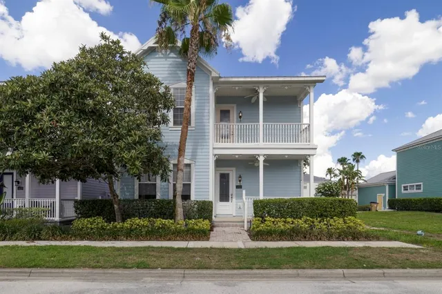 a view of a white house next to a yard