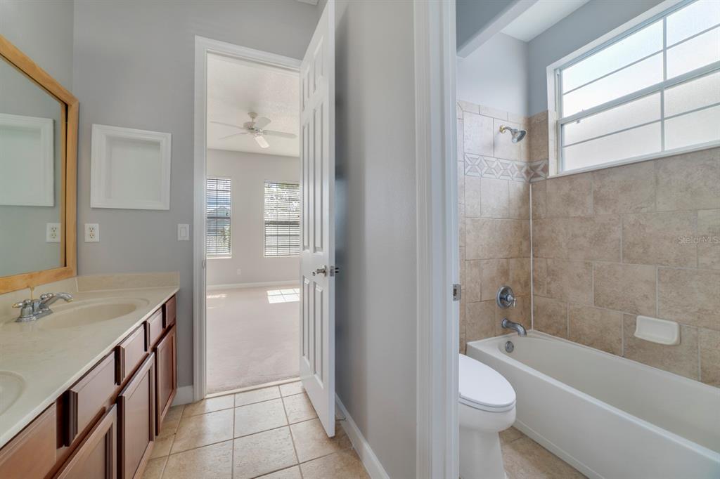 1426 Fairview Circle Reunion, FL 34747 - Photo 21 of 35 a bathroom with a sink a toilet and shower
