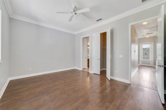 a view of an empty room with wooden floor