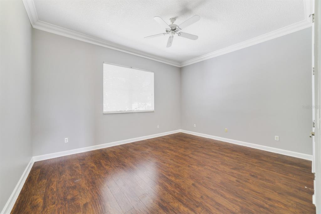 1426 Fairview Circle Reunion, FL 34747 - Photo 26 of 35 an empty room with wooden floor and windows