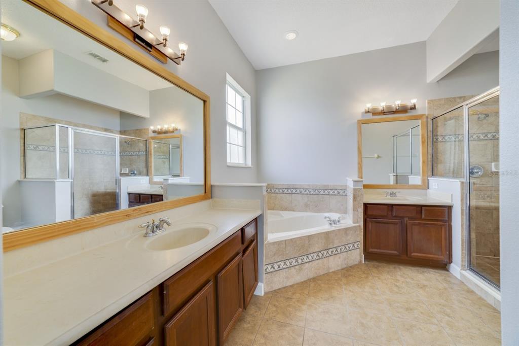1426 Fairview Circle Reunion, FL 34747 - Photo 27 of 35 a spacious bathroom with a tub sink shower and mirror