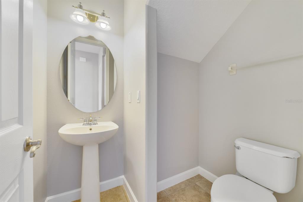 1426 Fairview Circle Reunion, FL 34747 - Photo 7 of 35 a bathroom with a toilet sink and mirror