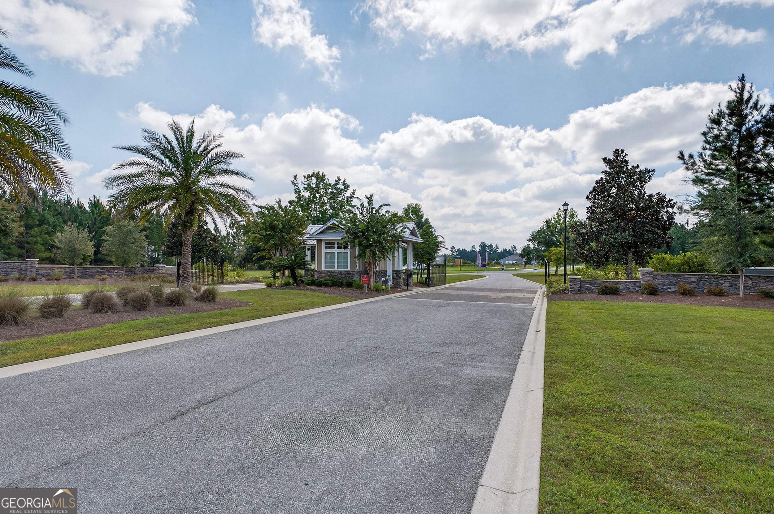 615 Breakwater Loop Kingsland, GA 31548 - Photo 24 of 25 a view of a house with a big yard and a large trees
