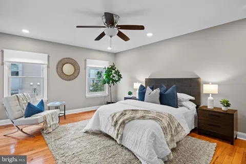 a bedroom with a bed a fireplace and a chandelier