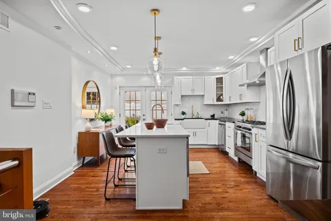 a kitchen with a white cabinets stove and sink