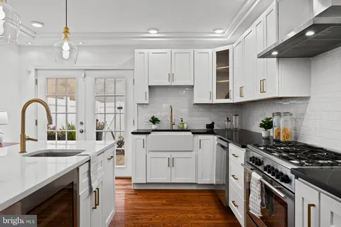a kitchen with stainless steel appliances kitchen island a island in the center a sink a stove and a center