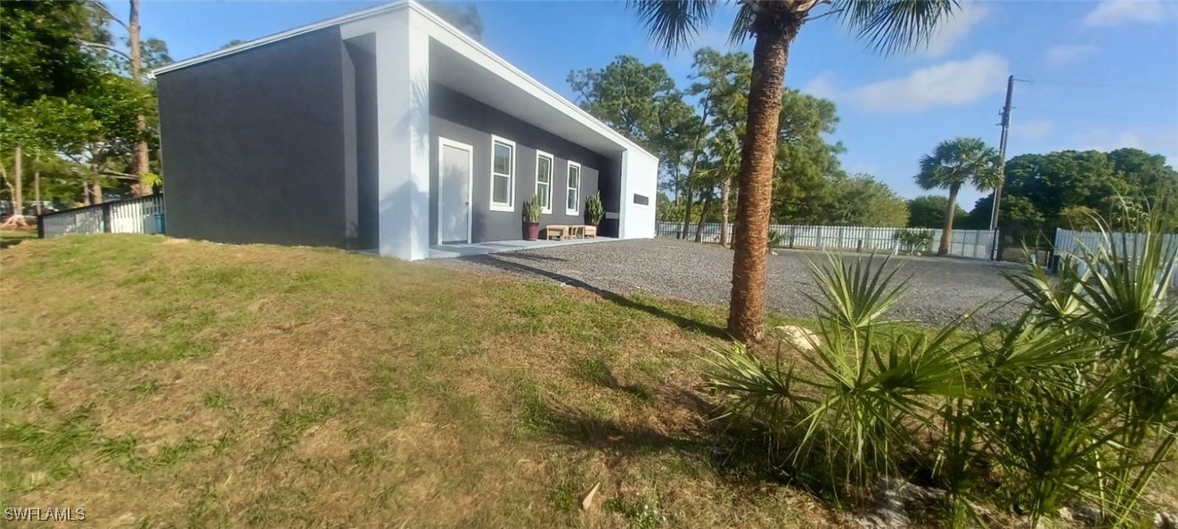 810 South Cabbage Palm Street Clewiston, FL 33440 - Photo 2 of 32 a view of a house with a yard and potted plants