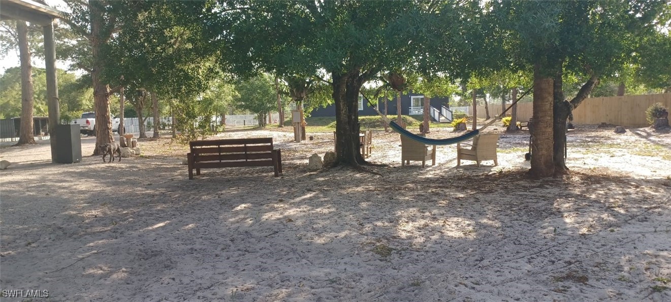 810 South Cabbage Palm Street Clewiston, FL 33440 - Photo 32 of 32 a view of a bench in a yard
