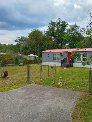 a view of an house with a yard