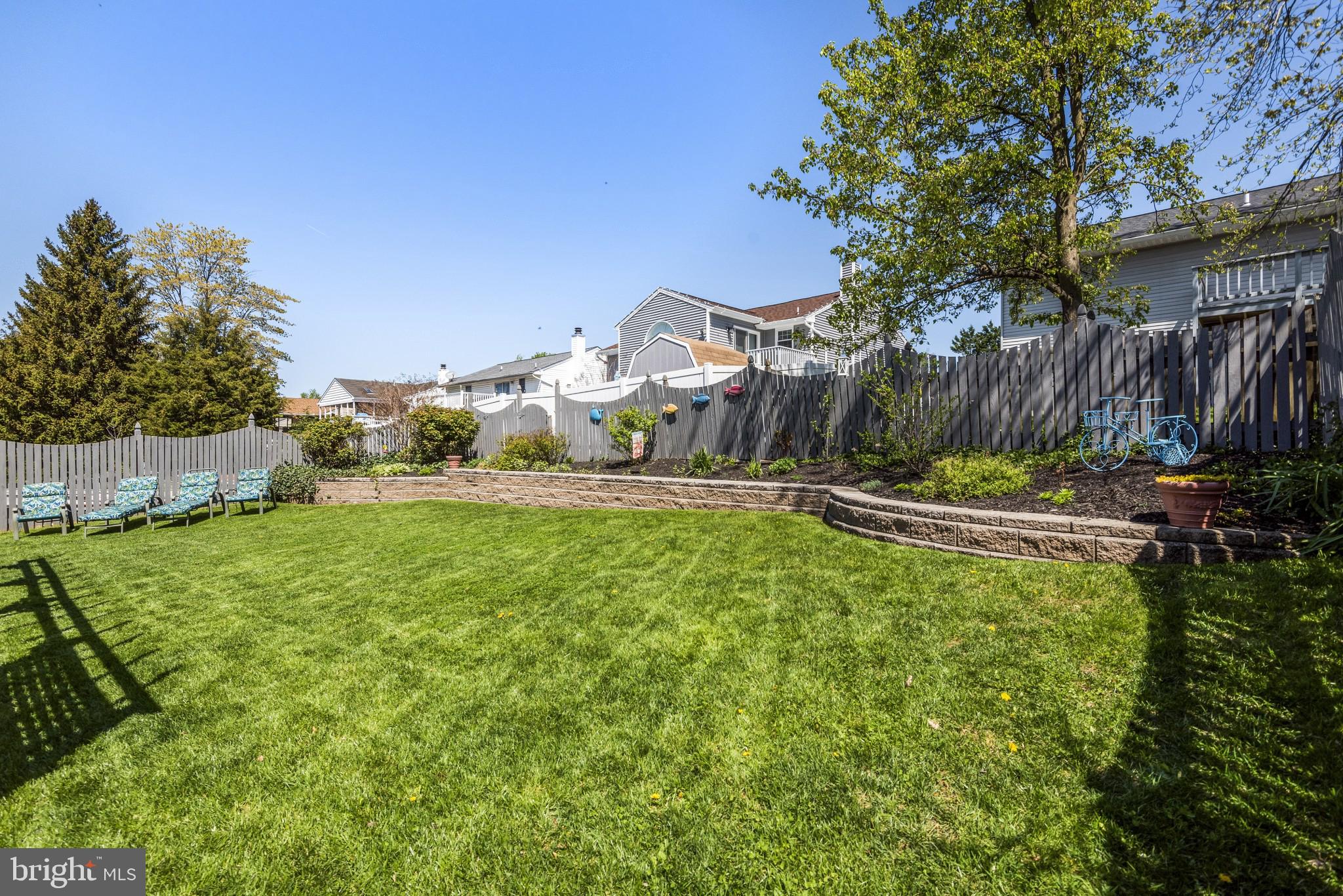 421 Bathurst Road Baltimore, MD 21228 - Photo 21 of 31 Fully fenced backyard with stone retaining wall