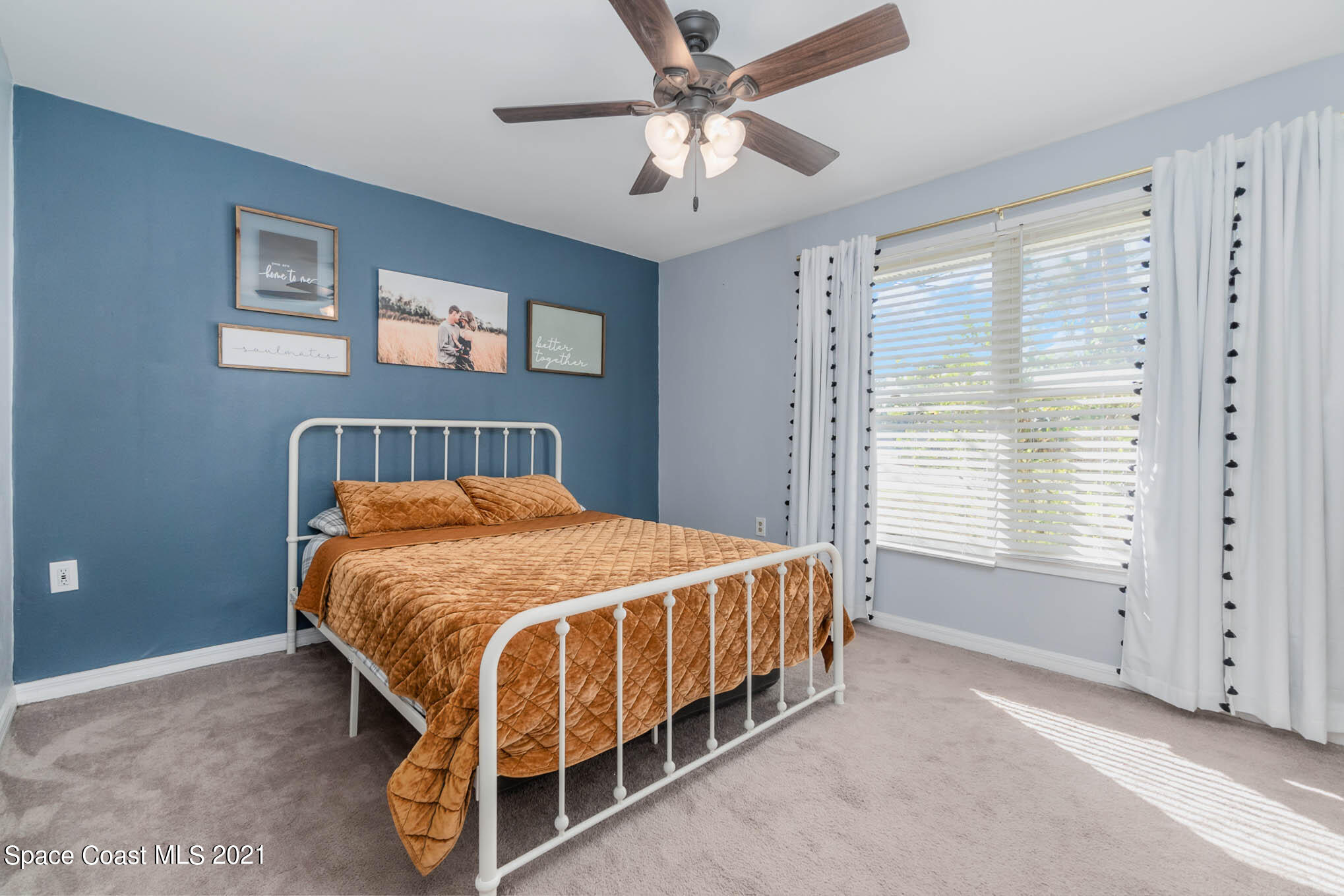 6921 Bentley Road Cocoa, FL 32927 - Photo 12 of 26 a bedroom with a bed and window