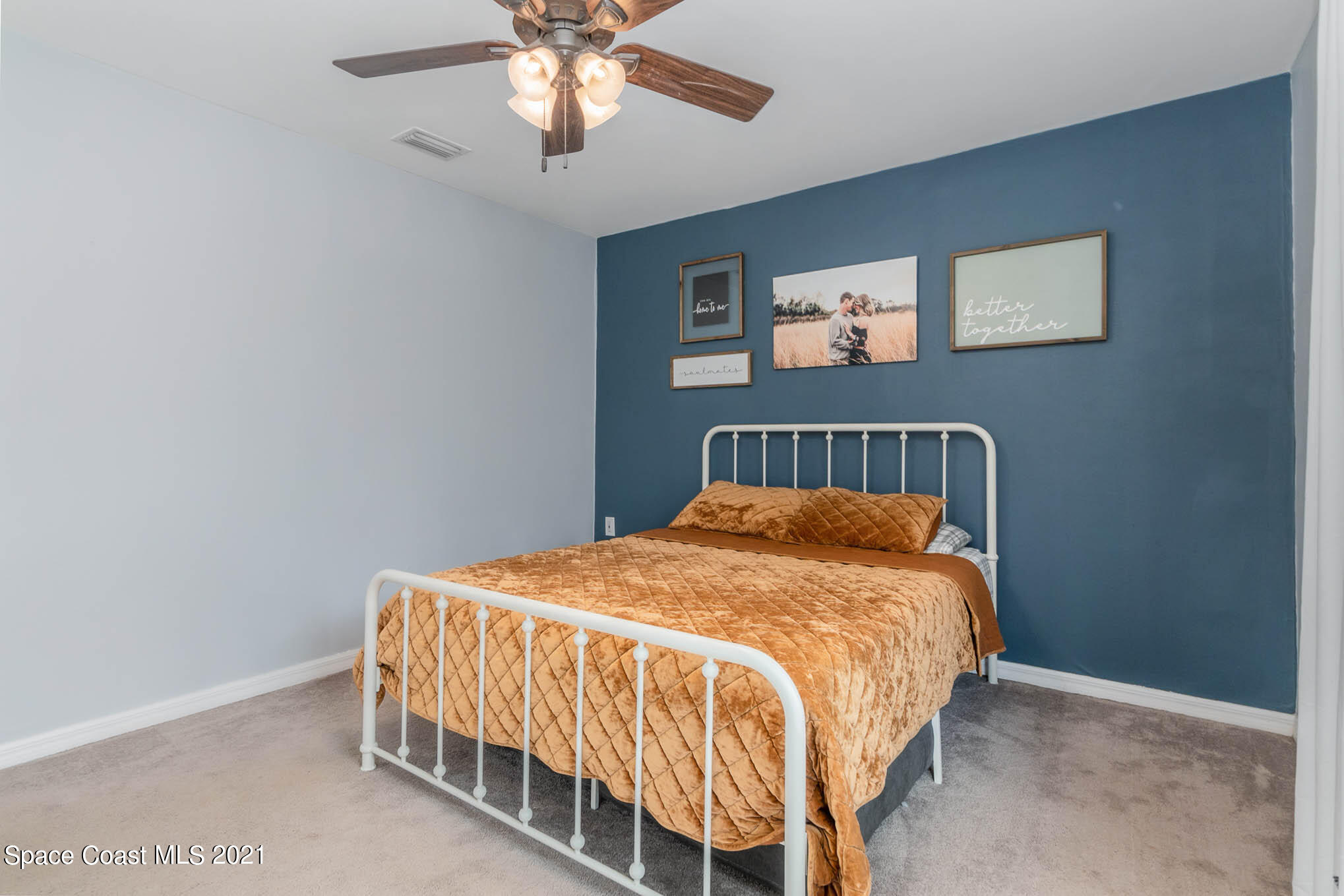6921 Bentley Road Cocoa, FL 32927 - Photo 13 of 26 a bedroom with a bed and a chandelier