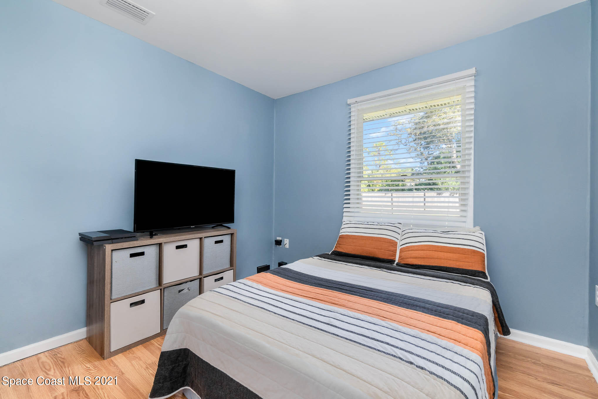 6921 Bentley Road Cocoa, FL 32927 - Photo 15 of 26 a bedroom with a bed and a flat screen tv