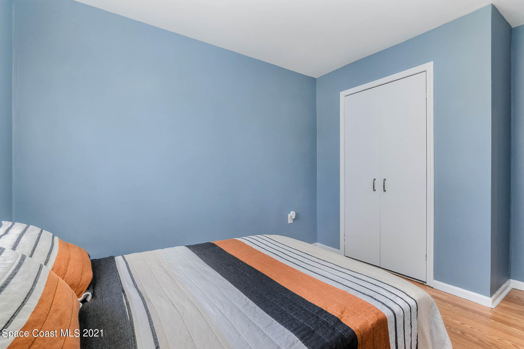 6921 Bentley Road Cocoa, FL 32927 - Photo 17 of 26 a bedroom with a bed and a window