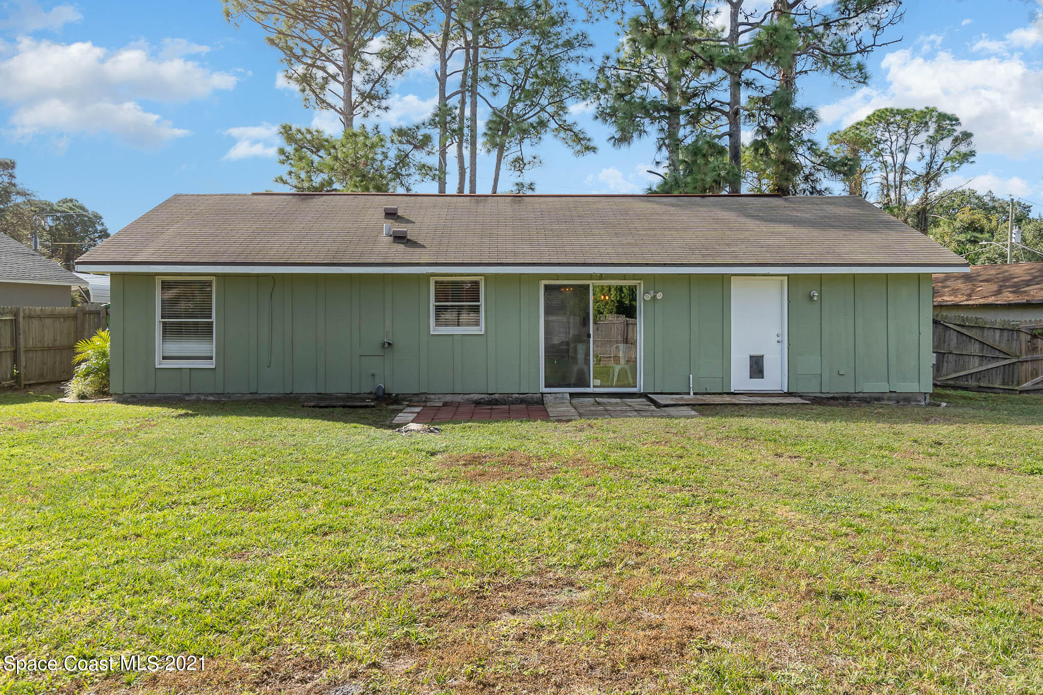 6921 Bentley Road Cocoa, FL 32927 - Photo 19 of 26 a house that has a tree in it