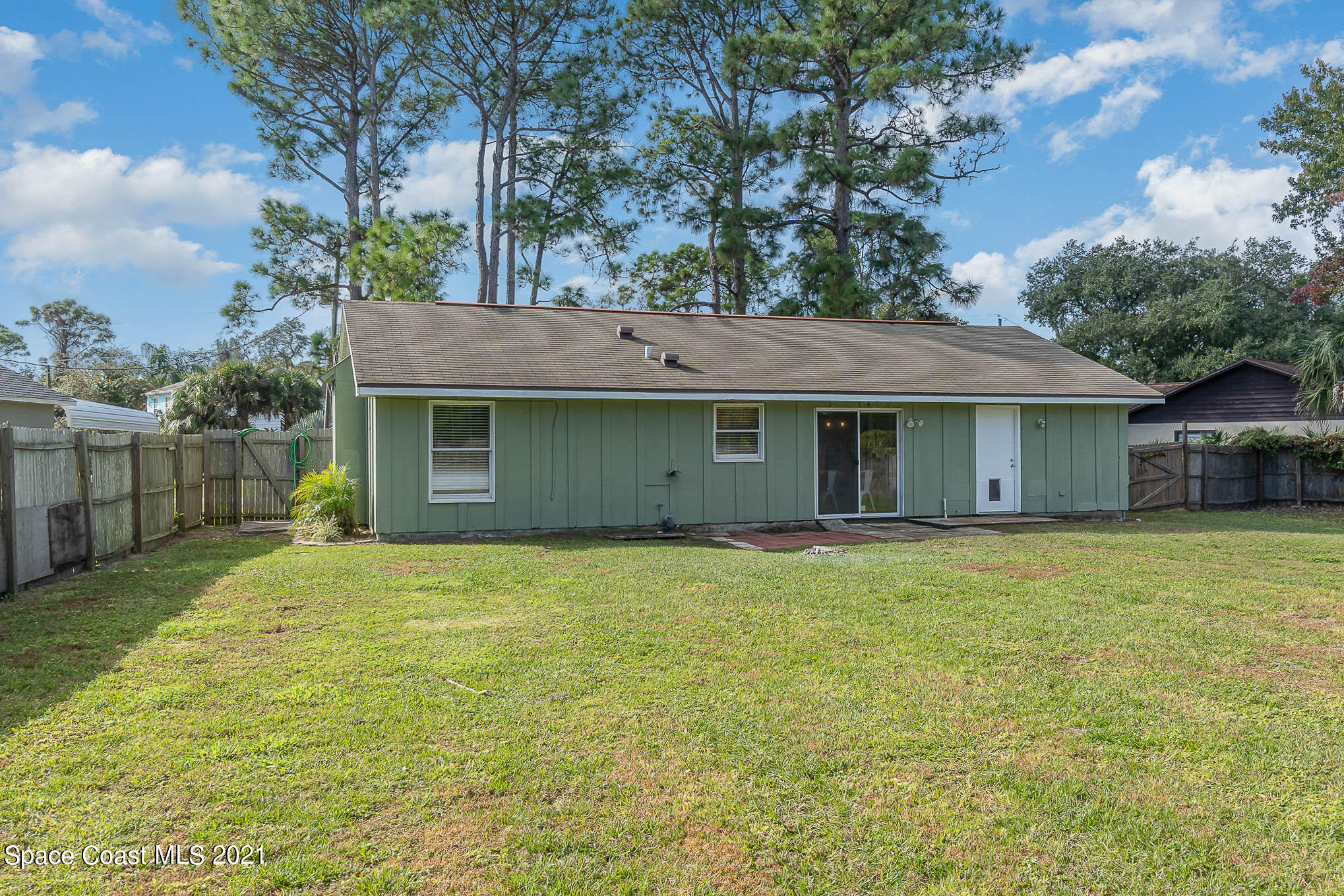 6921 Bentley Road Cocoa, FL 32927 - Photo 20 of 26 a front view of a house with a garden