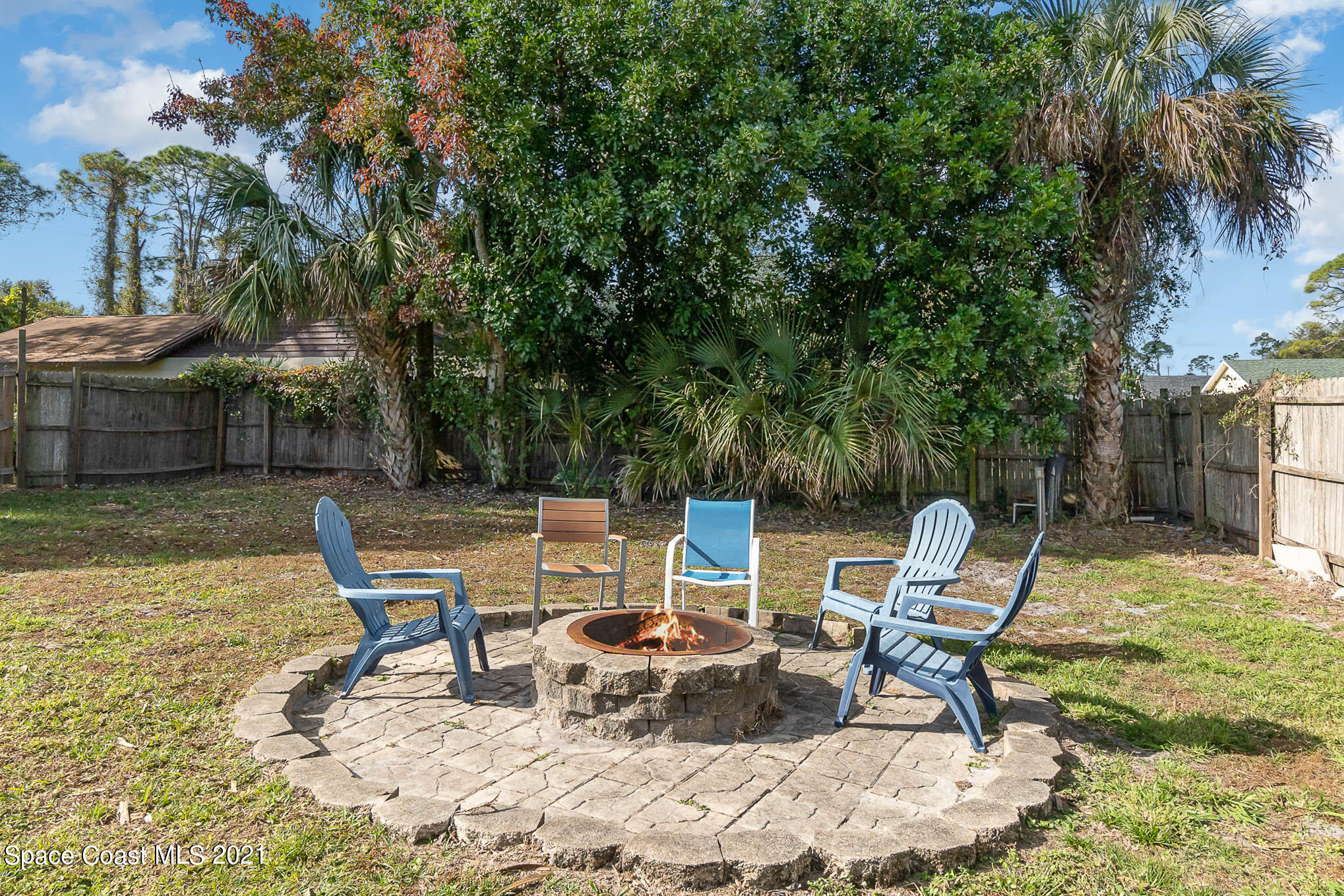 6921 Bentley Road Cocoa, FL 32927 - Photo 22 of 26 a view of backyard with seating area and trees