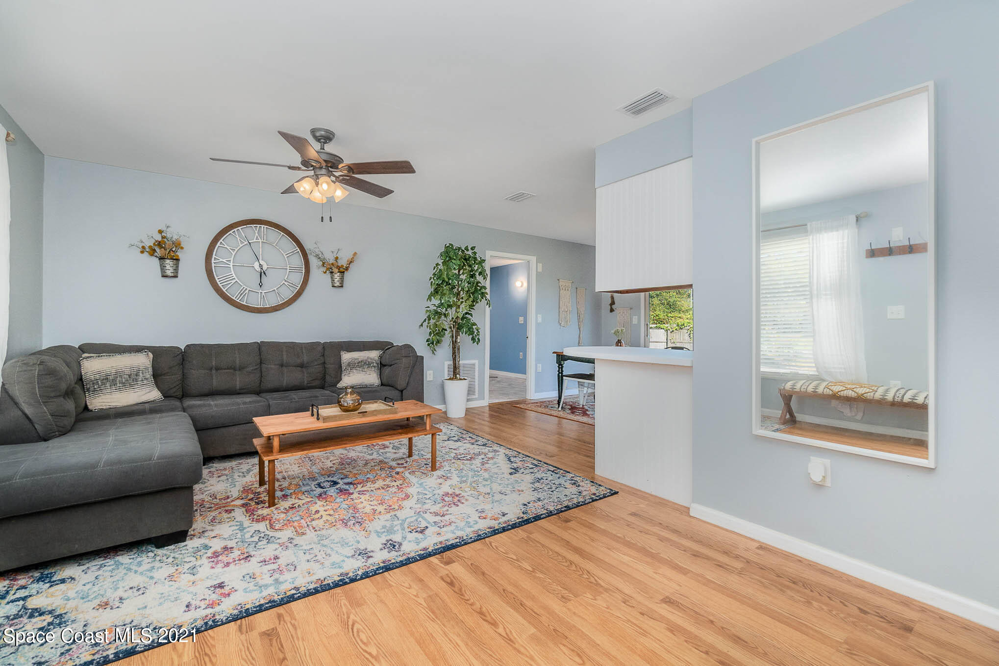 6921 Bentley Road Cocoa, FL 32927 - Photo 5 of 26 a living room with furniture and a clock