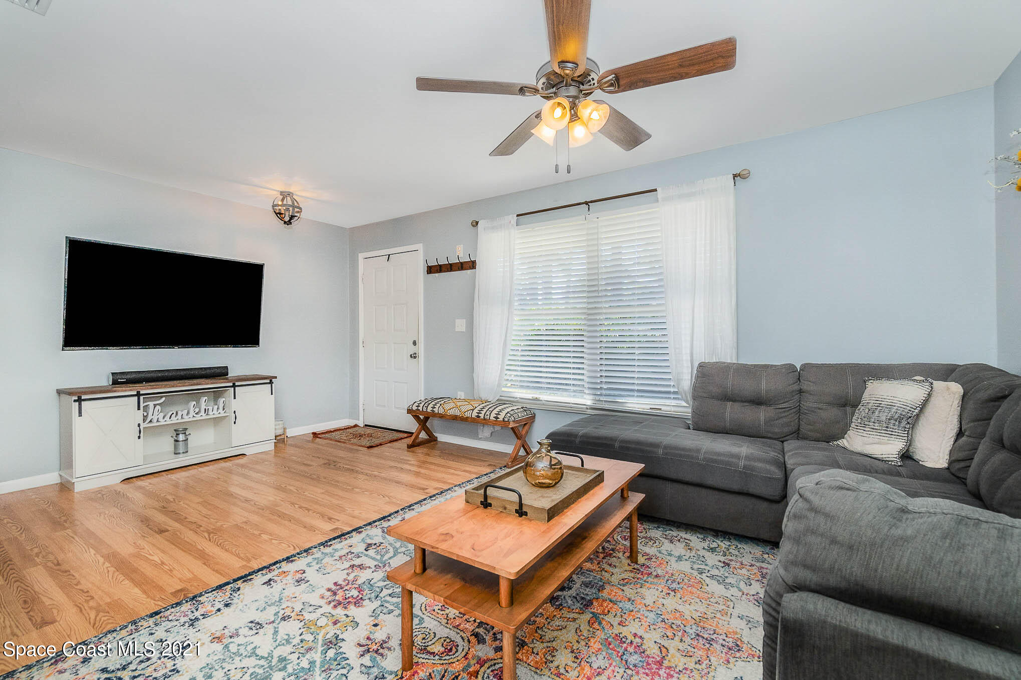 6921 Bentley Road Cocoa, FL 32927 - Photo 6 of 26 a living room with furniture and a flat screen tv