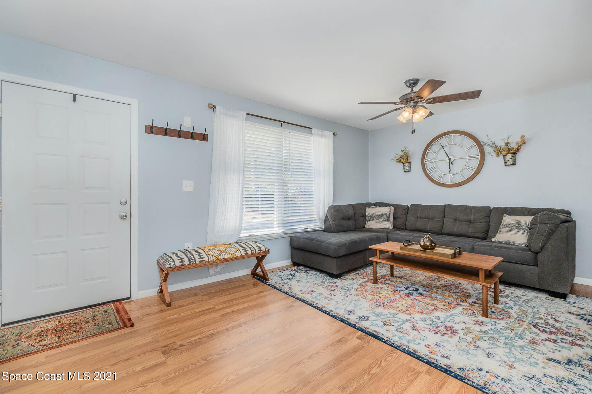 6921 Bentley Road Cocoa, FL 32927 - Photo 7 of 26 a living room with furniture a rug and white walls