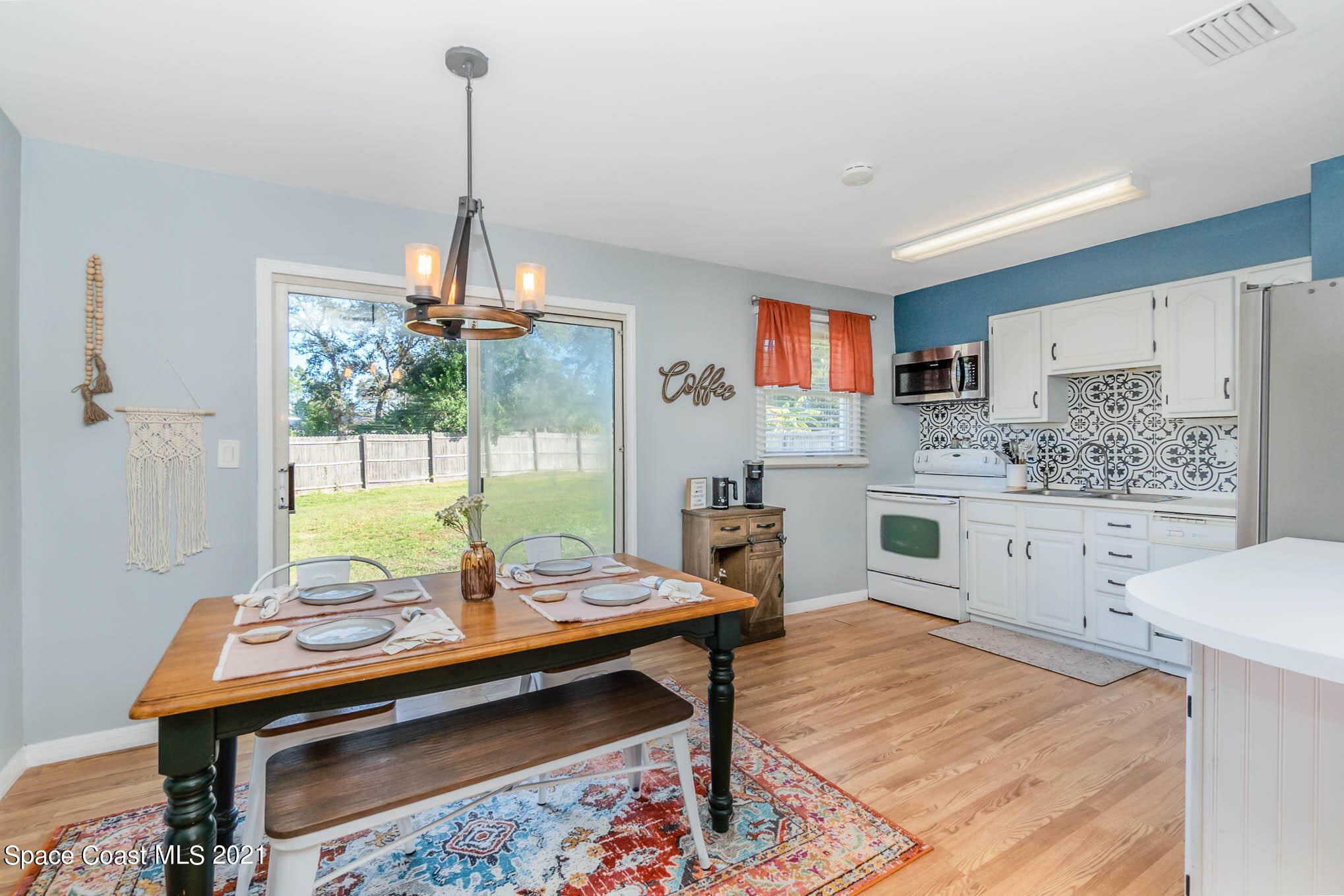 6921 Bentley Road Cocoa, FL 32927 - Photo 8 of 26 a kitchen with a table chairs and microwave