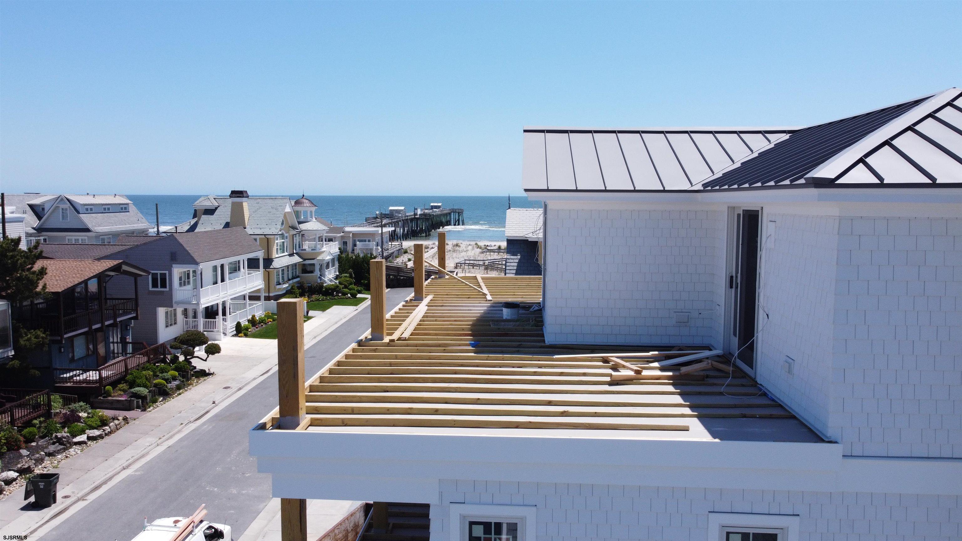 108 South Exeter Avenue Margate City, NJ 08402 - Photo 8 of 42 a view of a balcony with chairs and potted plants