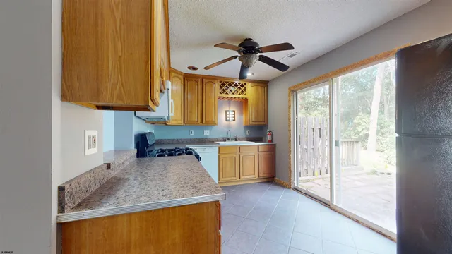 a kitchen with stainless steel appliances granite countertop a sink a stove and a refrigerator