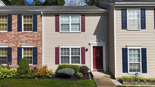 a view of a house with a small yard and plants