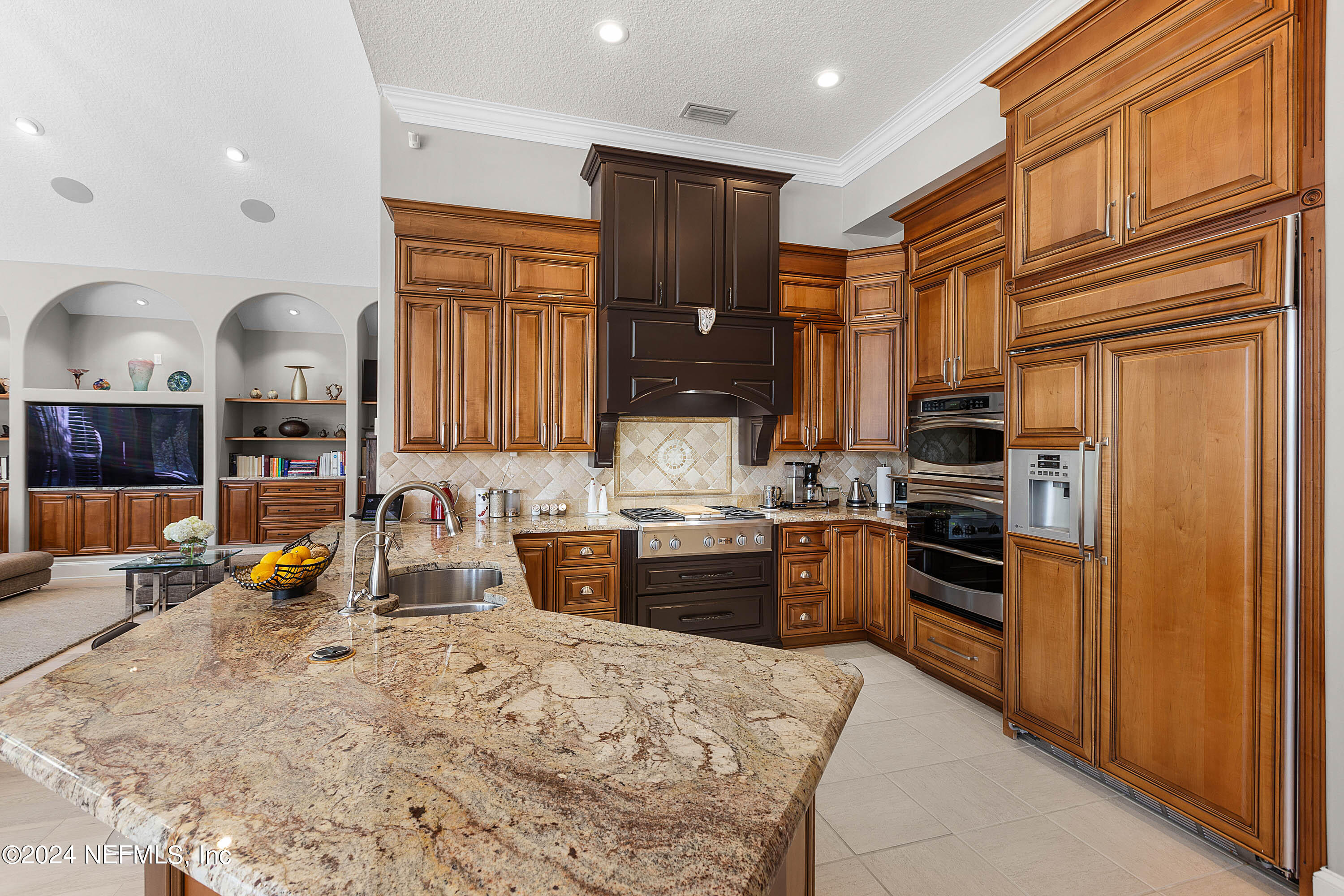 9975 Vineyard Lake Road East Jacksonville, FL 32256 - Photo 18 of 57 a kitchen with stainless steel appliances granite countertop a refrigerator stove top oven and sink