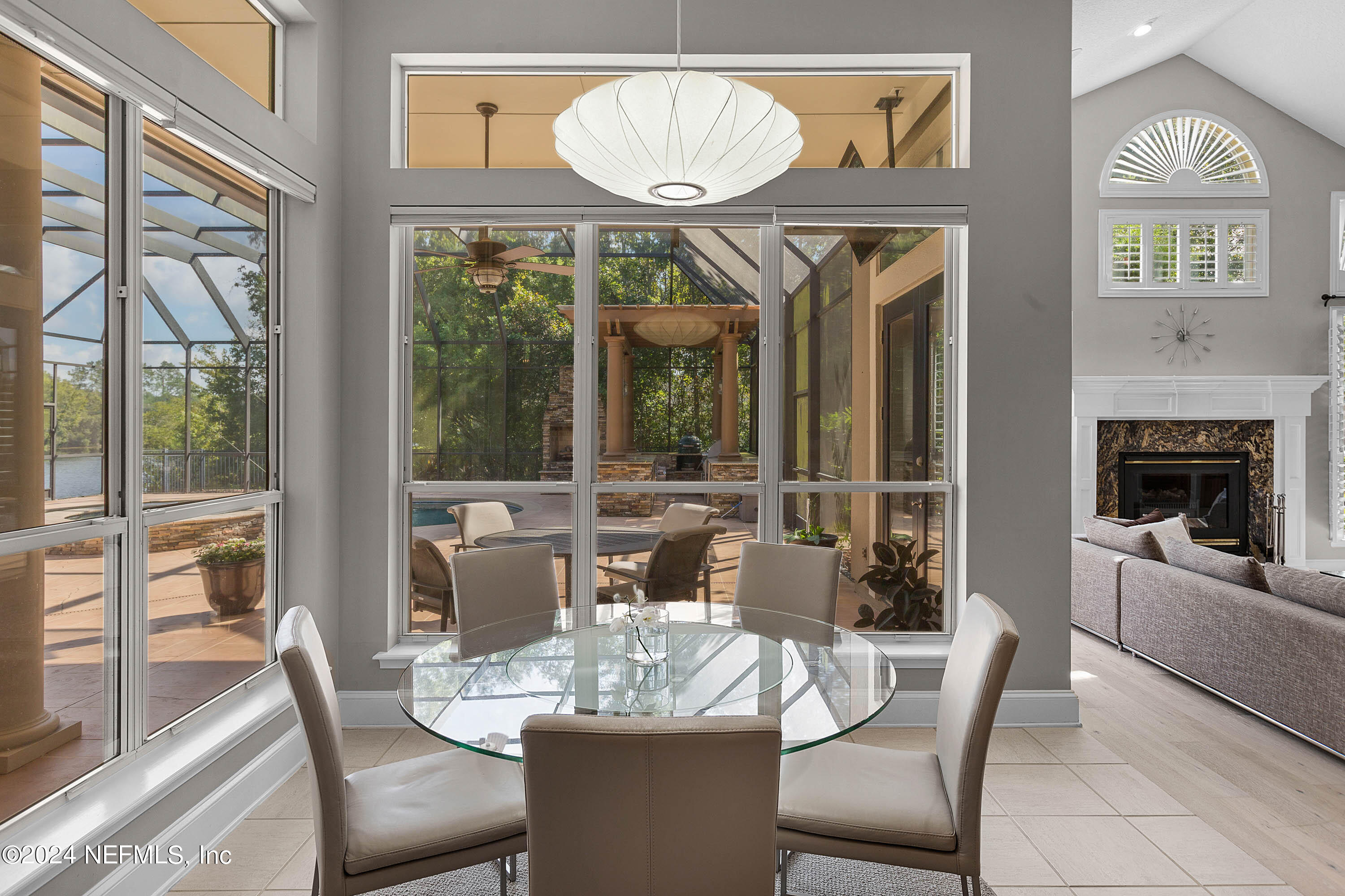 9975 Vineyard Lake Road East Jacksonville, FL 32256 - Photo 22 of 57 a dining room with furniture a chandelier and wooden floor