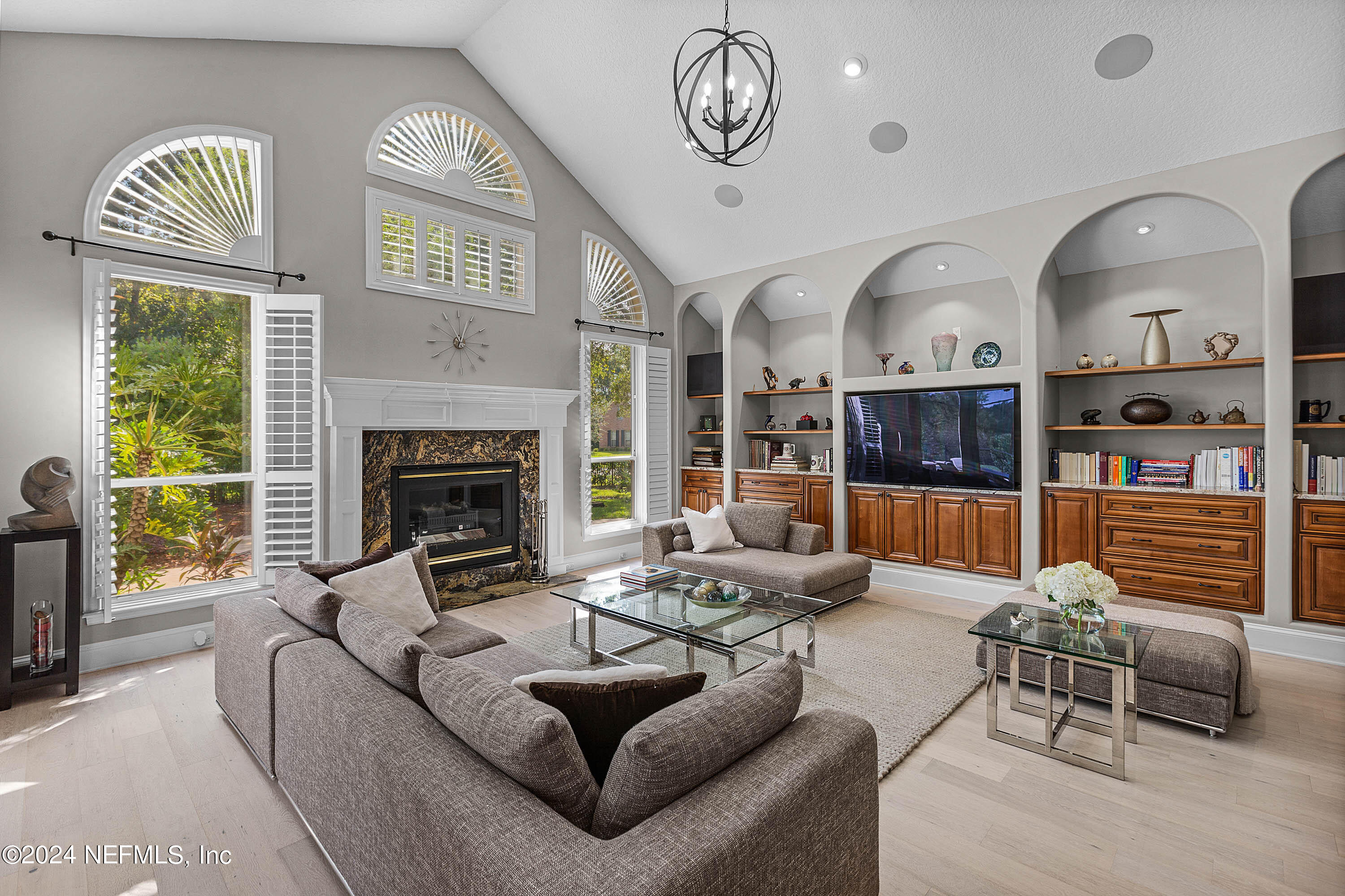 9975 Vineyard Lake Road East Jacksonville, FL 32256 - Photo 23 of 57 a living room with furniture a fireplace and a large window